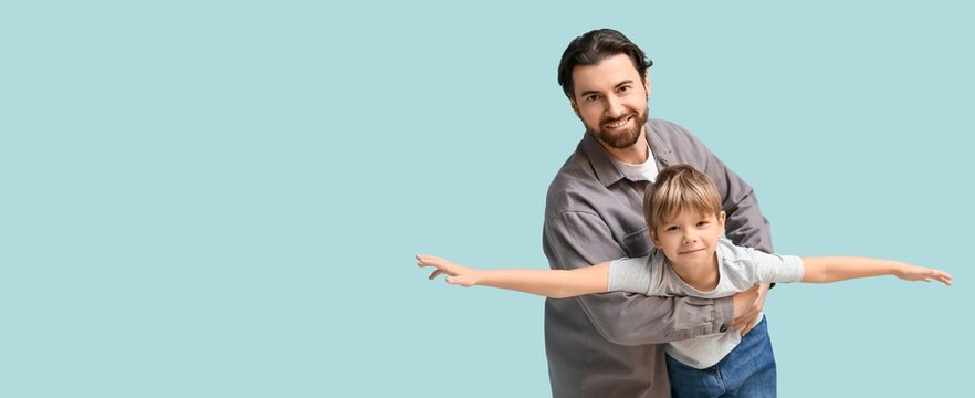 Portrait of happy dad and son playing on light blue background with space for text. Father's day - Powered by Adobe
