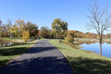 The empty pathway in the park on a sunny fall day.