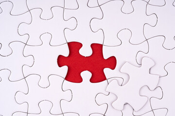 Closeup a set of white jigsaw puzzle and one piece of them is missing for concept and idea purpose