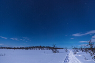 Marked path in the snow.Beautiful evening in winter season in Kiruna Lapland, Sweden.