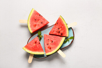 PLate with sweet watermelon sticks and mint on white background