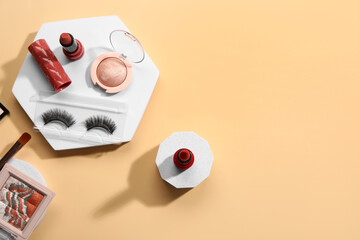 Stands with different decorative cosmetics on beige background