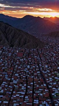 Aerial sunset over mountain cityscape with vibrant sky and expansive horizon