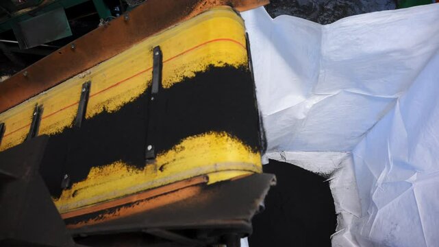 A powerful shredder breaks down old tires for future manufacturing use.