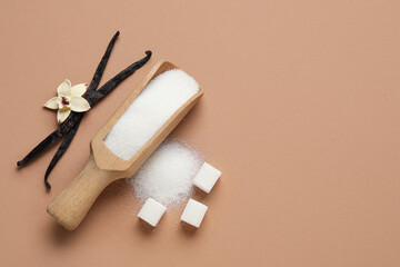 Wooden scoop with aromatic vanilla sugar, flower and sticks on brown background