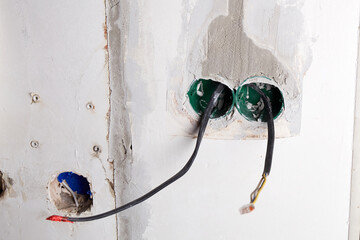 The electrical boxes for the wires are built into the wall, and the wires stick out during the...