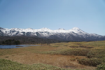 Snow-covered Shiretoko mountains and blue sky
