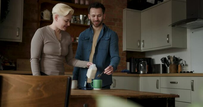 Couple making a cup of tea together in the kitchen
