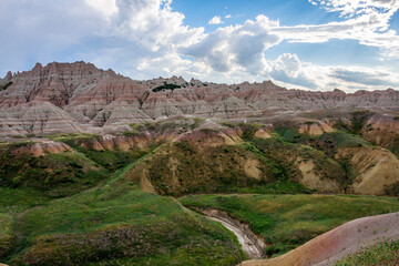 Multicolored Badlands Landscape Under a Partly Cloudy Sky