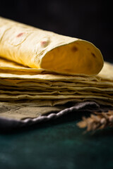 Lavash flat bread on green background
