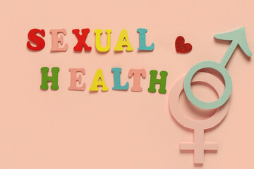 Colorful letters with text SEXUAL HEALTH, male and female symbols on pink background