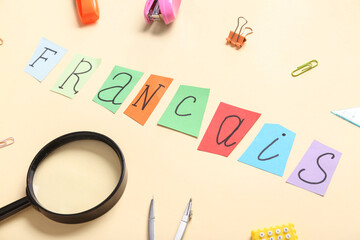 Composition with word FRANCAIS and different stationery on color background