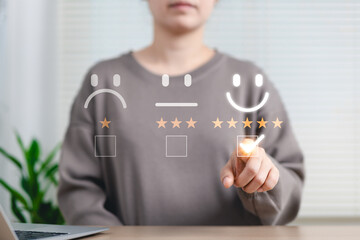 Customer satisfaction feedback and rating concept. Woman selecting five-star happy face rating on...