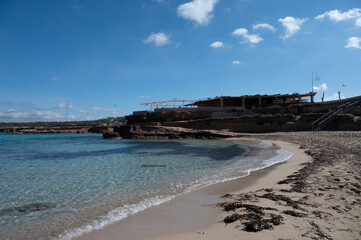 Crystal clear waters and sandy beach in Ibiza reveal coastal beauty in a serene seaside location