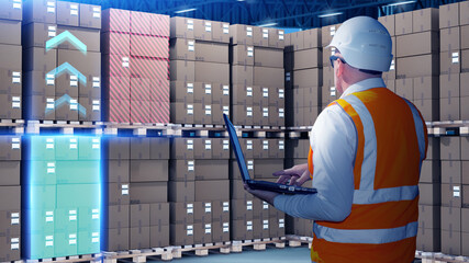 Man storekeeper among pallets with boxes. Warehouse employee at work. Storekeeper determines cargo...