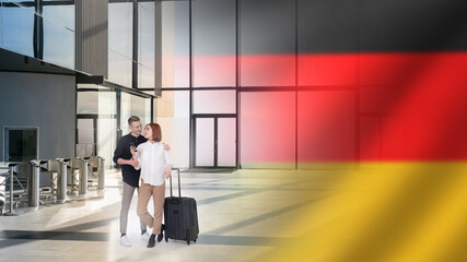 Tourists from Germany. Couple in love in airport terminal. Man and woman with travel suitcase. Two tourists are heading to Germany. Guy and girl near turnstiles at airport. Tourists travel to Germany