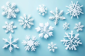 Fototapeta premium White paper cut snowflakes scattered on a light blue background