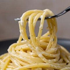 A delicious plate of creamy carbonara pasta with bacon and fresh basil