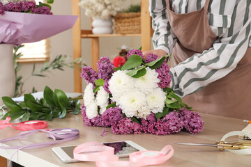 Female florist making bouquet in flower shop