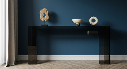 A modern minimalist console table displays elegant organic sculptures and a bowl, creating a serene and sophisticated atmosphere in a stylish home with dark glass and a deep blue wall.