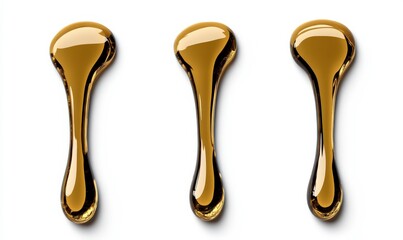 Three smooth and glossy drops of golden liquid oil on a white background, showcasing texture and shape for creative culinary and beauty applications