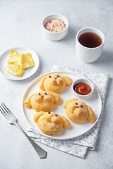 Potato croquettes in the form of dog or rabbit  with filling in a plate