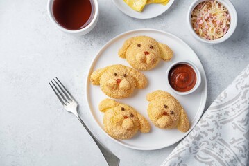 Potato croquettes in the form of dog or rabbit  with filling in a plate