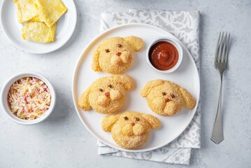 Potato croquettes in the form of dog or rabbit  with filling in a plate