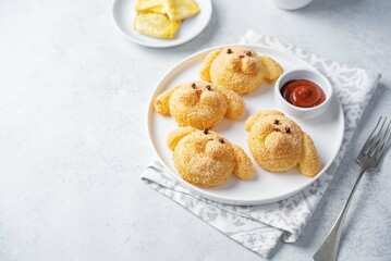 Potato croquettes in the form of dog or rabbit  with filling in a plate
