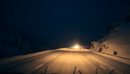 Night drive through a snowy mountain pass, headlights casting long shadows, deep atmospheric winter aesthetic