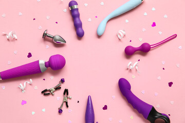 Frame made of different sex toys on pink background
