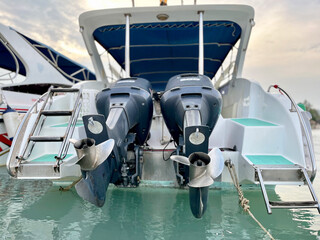 bow of a boat, Close up of a shiny boat propeller attached to an outboard motor, reflecting light...