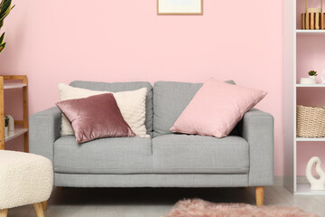 Comfortable sofa with cushions in living room