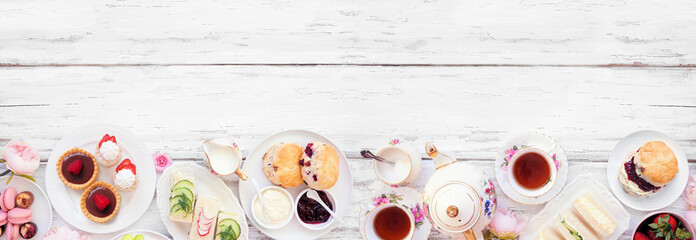 Afternoon tea bottom border against a white wood banner background. Vintage tea set, finger...