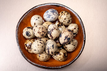 Fresh small spotted partridge or quail bird eggs uncooked