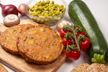 Round vegetarian patties or burgers made from grains, soybeans, vegetables and legumes