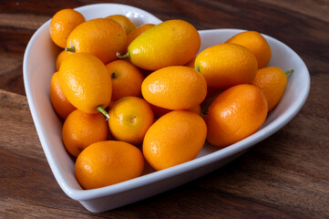 Delicious small citrus fruits orange kumquats close up