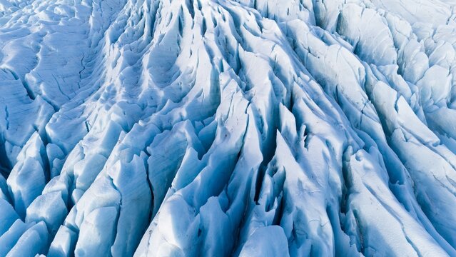 Aerial view of glacier from above, ice texture landscape, beautiful nature blue background from Vatnajokull, Iceland.
White and blue ice texture. Melting glaciers, global warming. Sunny day 