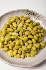 Asian vegetarian food cooked green soybeans on board