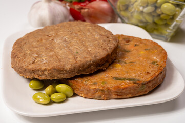 Round vegetarian patties or burgers made from grains, soybeans, vegetables and legumes
