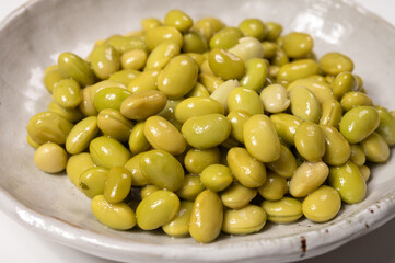 Asian vegetarian food cooked green soybeans on board