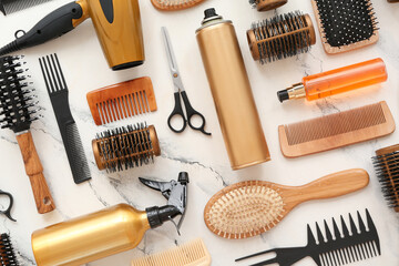 Different hairdresser's accessories on marble background