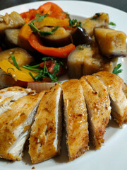 Sliced roasted chicken breast with sauteed eggplant, bell peppers, and herbs healthy dinner