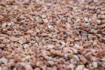 Close-up view of a pile of smooth, grey pebbles for landscaping