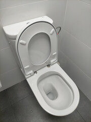 an open cup of water, a closed cup of water, white in color and the surface also white in color