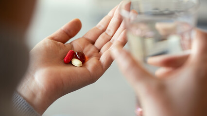 Young woman taking a pill