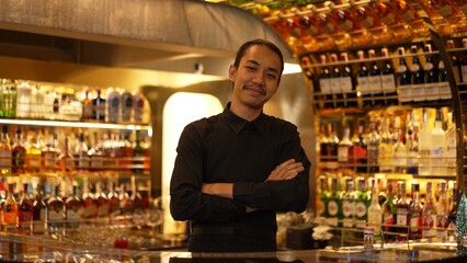 Smart Asian bartender using stirring mixed alcohol syrup into glass with ice for on the rock served mixing looking camera zoom out special refresh cocktail nightlife mixology at nightclub. Vinosity.