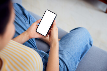 Smartphone mockup. Woman using phone sitting sofa at home