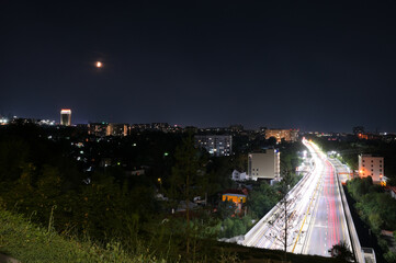 Night Almaty city, highway with light trails