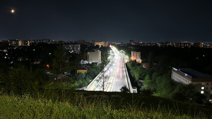 Long exposure car lights traces on highway in the night. Almaty
